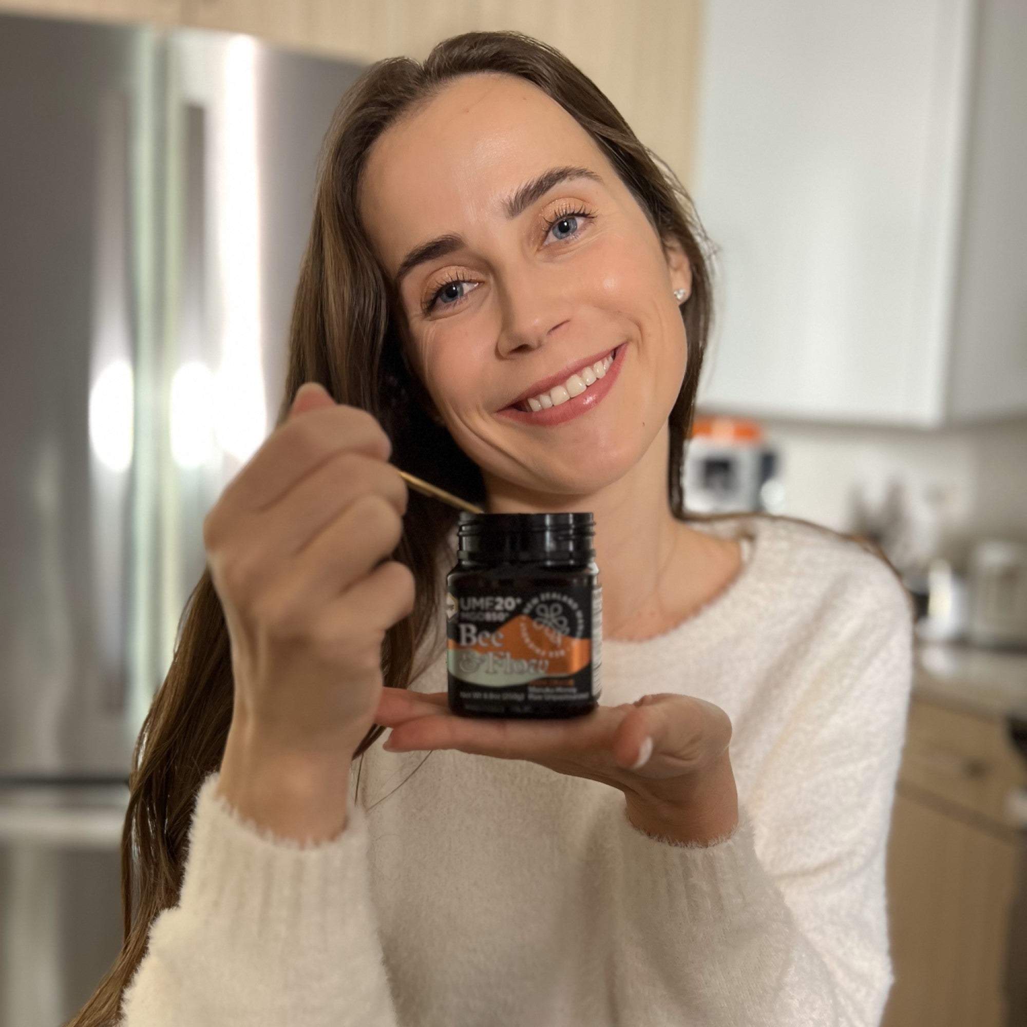 Model posing with jar of honey